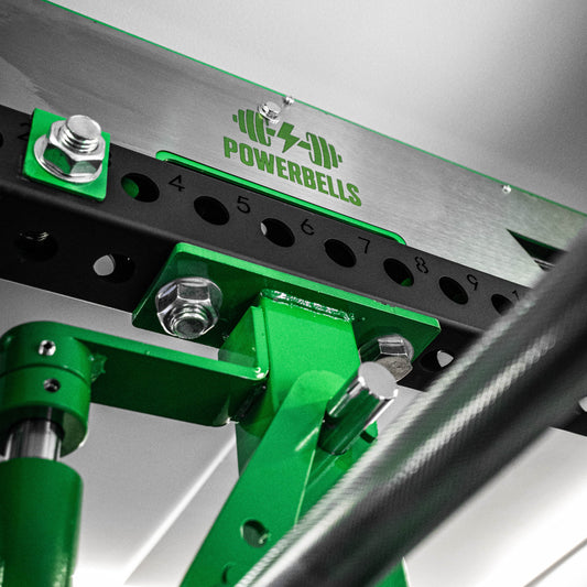 Green and black PowerBells power cage on a white background